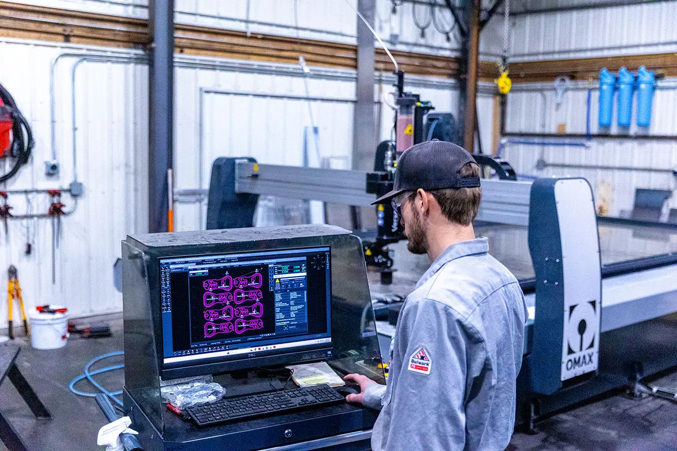 Elite Fabz Technician reviewing drawing for waterjet cutting