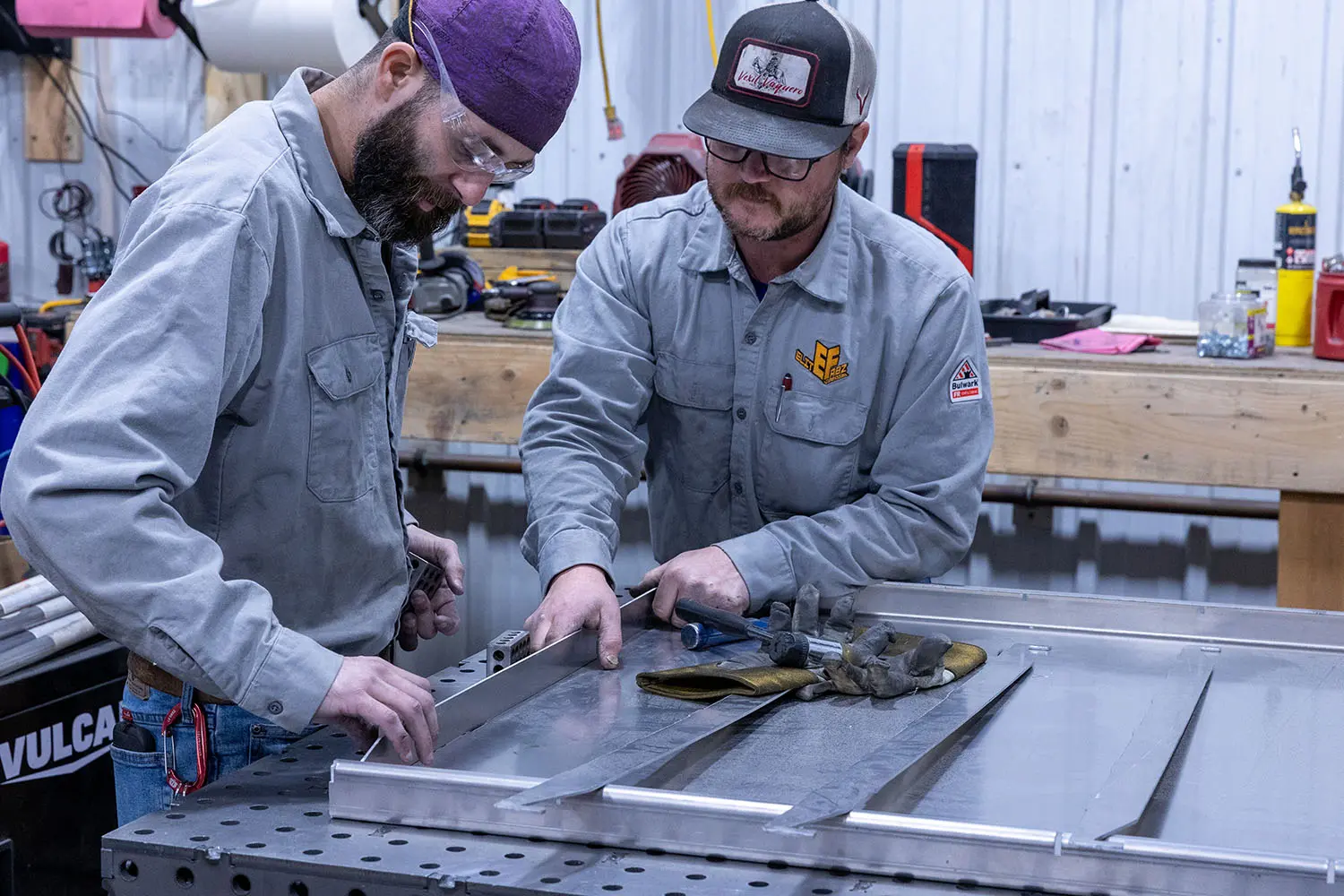Two Fabricators at Elite Fabz in Rapid City lay out metal pieces for welding